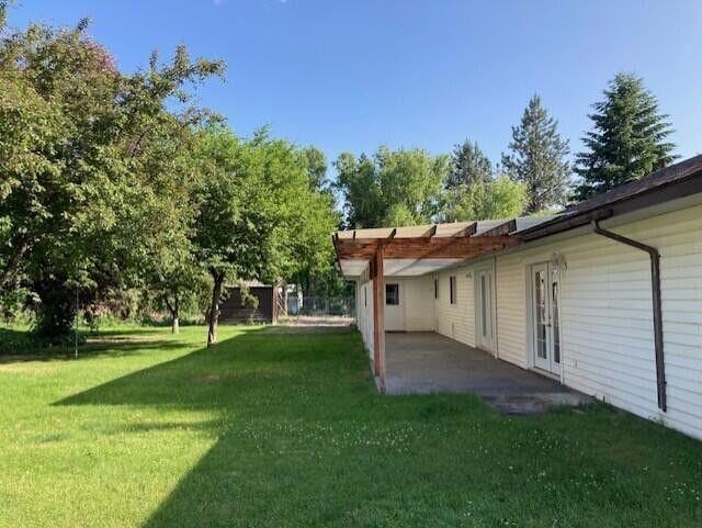 1327 Columbia Crest Way, Kettle Falls, WA 99141 - view of green lawn with a patio area and a pergola
