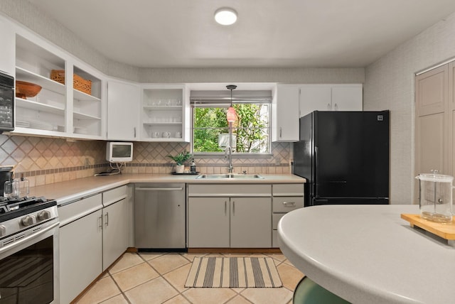 1827 S Arthur St, Spokane, WA 99203 - kitchen with stainless steel appliances, open shelves, decorative backsplash, and light countertops
