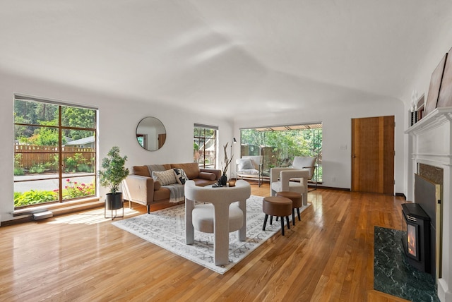 1827 S Arthur St, Spokane, WA 99203 - living room featuring wood finished floors, vaulted ceiling, and a wood stove