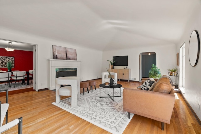 1827 S Arthur St, Spokane, WA 99203 - living area featuring wood finished floors, lofted ceiling, and a premium fireplace