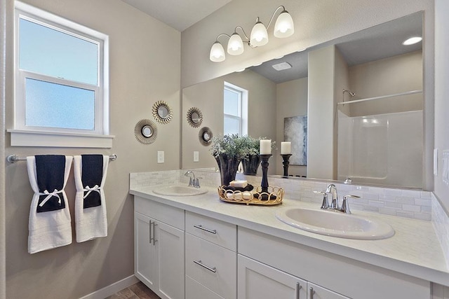 18126 E Barclay Ct Unit 3/4Snowbrush, Spokane Valley, WA 99016 - bathroom with double vanity, decorative backsplash, and a shower