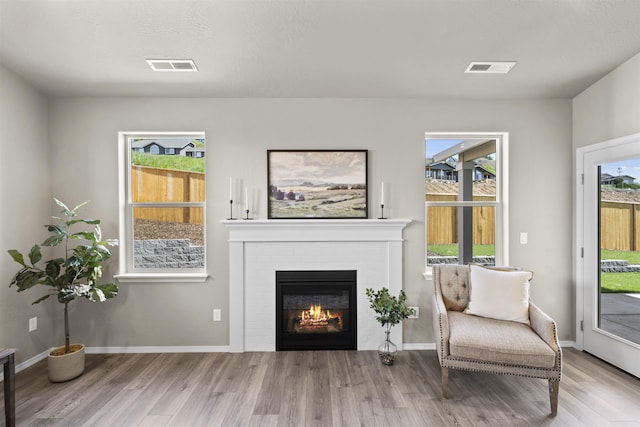 18126 E Barclay Ct Unit 3/4Snowbrush, Spokane Valley, WA 99016 - sitting room featuring wood finished floors and a brick fireplace