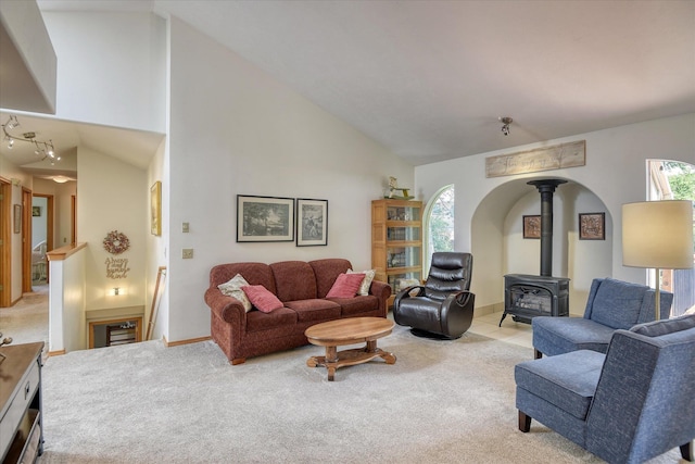 4307 S Apollo St, Spokane, WA 99223 - living room featuring a wood stove, light carpet, and high vaulted ceiling