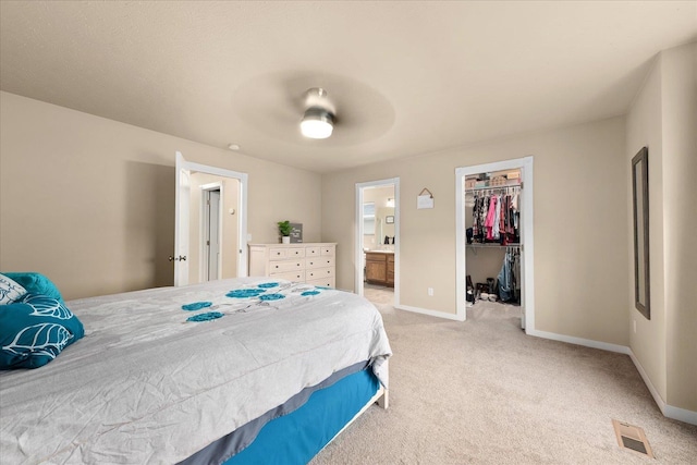 4031 S Bates Rd, Spokane Valley, WA 99206 - bedroom featuring light colored carpet, a walk in closet, a closet, ensuite bath, and ceiling fan