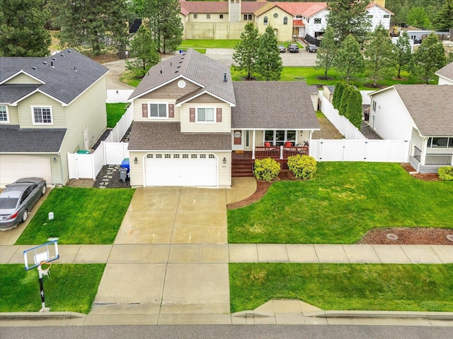 4031 S Bates Rd, Spokane Valley, WA 99206 - view of front of property with driveway, a garage, a residential view, a shingled roof, and a fenced backyard