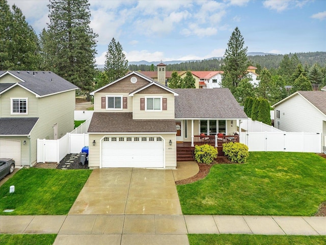 4031 S Bates Rd, Spokane Valley, WA 99206 - tri-level home with a gate, an attached garage, driveway, covered porch, and roof with shingles