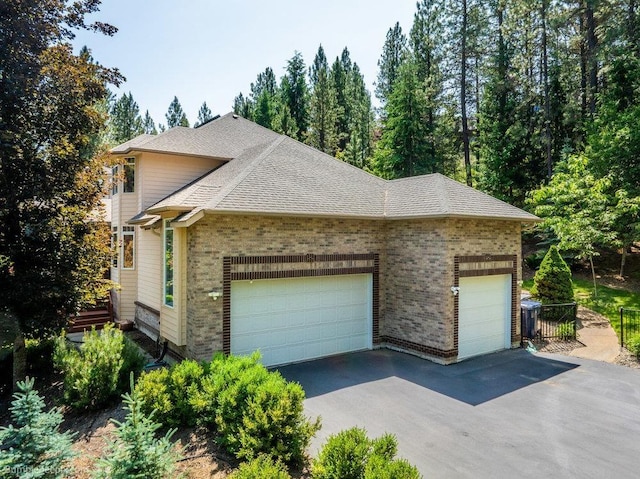 12910 S Fairway Ridge Ln, Spokane, WA 99224 - view of home's exterior with a garage, roof with shingles, brick siding, and driveway