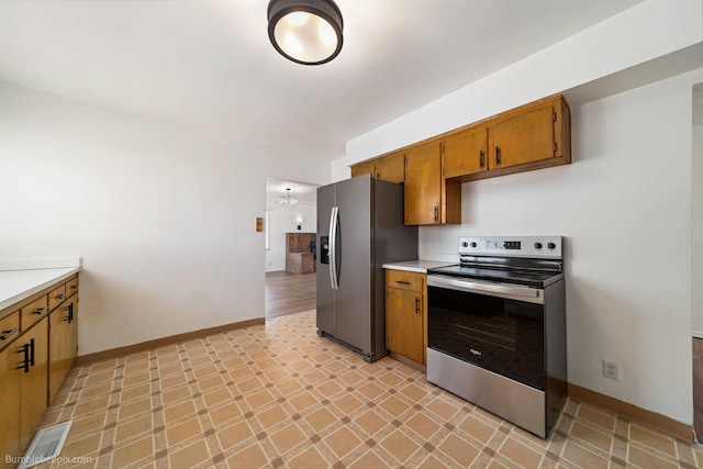 1306 W Joseph Ave, Spokane, WA 99205 - kitchen featuring appliances with stainless steel finishes, brown cabinets, light countertops, and light flooring