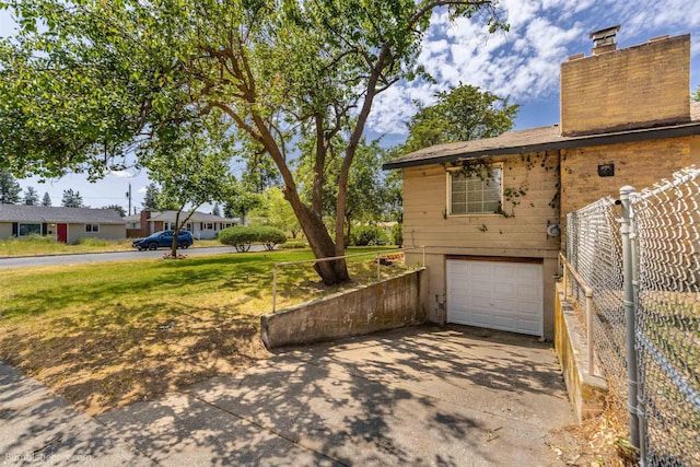1306 W Joseph Ave, Spokane, WA 99205 - view of property exterior with driveway, a garage, and a chimney