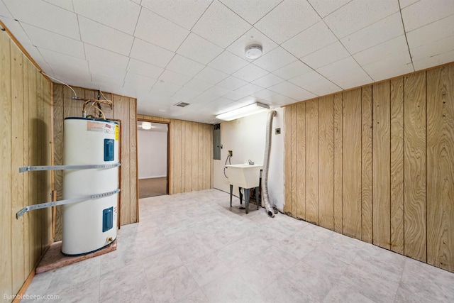 1306 W Joseph Ave, Spokane, WA 99205 - finished below grade area with water heater, wood walls, tile patterned floors, and electric panel