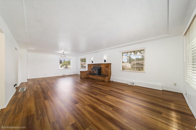 1306 W Joseph Ave, Spokane, WA 99205 - unfurnished living room with wood finished floors and a brick fireplace