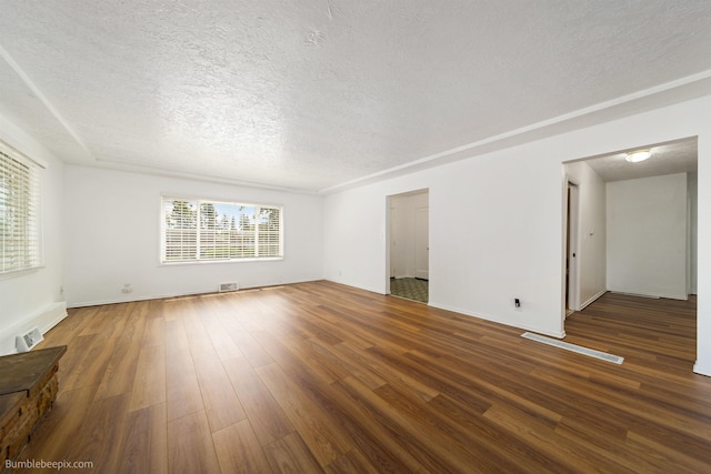 1306 W Joseph Ave, Spokane, WA 99205 - unfurnished living room with a textured ceiling and wood finished floors