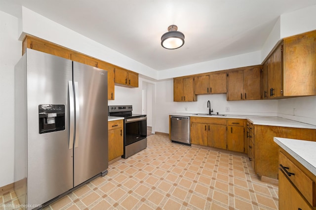 1306 W Joseph Ave, Spokane, WA 99205 - kitchen featuring stainless steel appliances, brown cabinetry, light countertops, and light flooring
