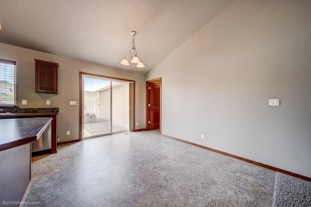 20051 E Meyers Ave, Liberty Lake, WA 99019 - unfurnished dining area featuring a chandelier, a textured ceiling, and vaulted ceiling