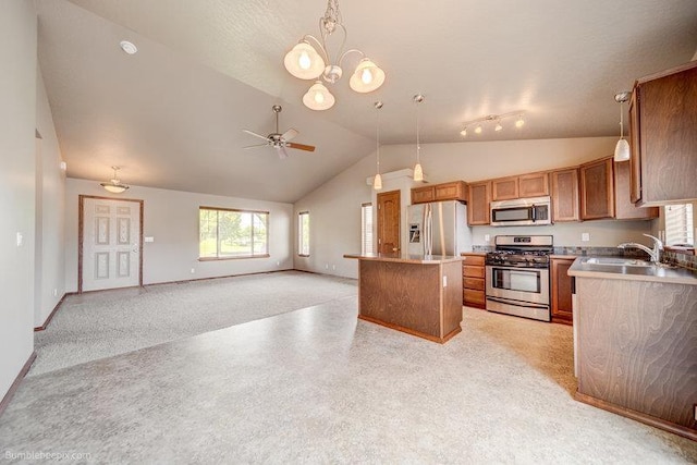 20051 E Meyers Ave, Liberty Lake, WA 99019 - kitchen featuring appliances with stainless steel finishes, lofted ceiling, a ceiling fan, brown cabinets, and open floor plan