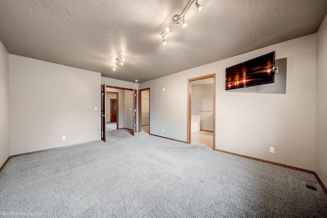 20051 E Meyers Ave, Liberty Lake, WA 99019 - unfurnished bedroom featuring a textured ceiling, light colored carpet, and connected bathroom