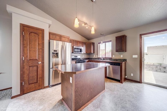 20051 E Meyers Ave, Liberty Lake, WA 99019 - kitchen featuring appliances with stainless steel finishes, a kitchen island, a textured ceiling, dark countertops, and lofted ceiling