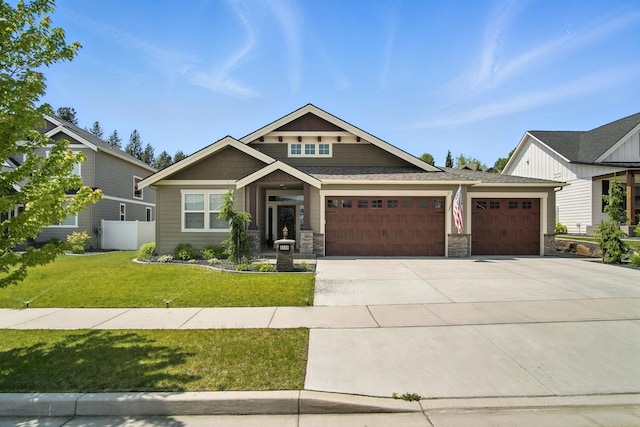 2630 S Fairmont Estates Ct, Greenacres, WA 99016 - craftsman-style house featuring an attached garage, concrete driveway, stone siding, and a front lawn