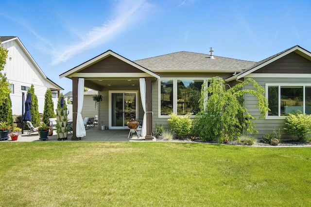 2630 S Fairmont Estates Ct, Greenacres, WA 99016 - back of property featuring a patio, a lawn, and a shingled roof