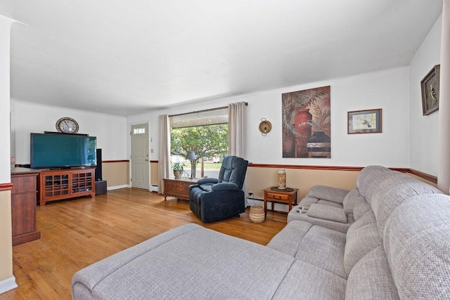 5204 N Belt St, Spokane, WA 99205 - living area with wood finished floors and a baseboard heating unit