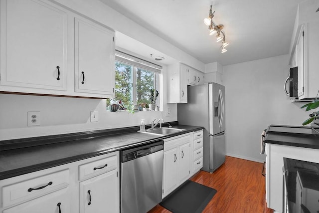 844 W Cliff Dr Unit 206, Spokane, WA 99204 - kitchen featuring appliances with stainless steel finishes, dark countertops, white cabinetry, and dark wood-style flooring