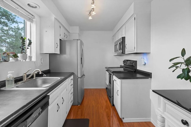 844 W Cliff Dr Unit 206, Spokane, WA 99204 - kitchen featuring appliances with stainless steel finishes, dark countertops, and wood finished floors
