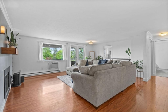 844 W Cliff Dr Unit 206, Spokane, WA 99204 - living area with a baseboard radiator, wood finished floors, ornamental molding, a fireplace, and a wall unit AC