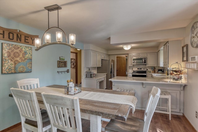 12720 E Kiowa Ct, Spokane Valley, WA 99206 - dining space with dark wood-style floors and a chandelier