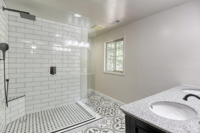 12720 E Kiowa Ct, Spokane Valley, WA 99206 - bathroom with tiled shower, double vanity, and tile patterned flooring