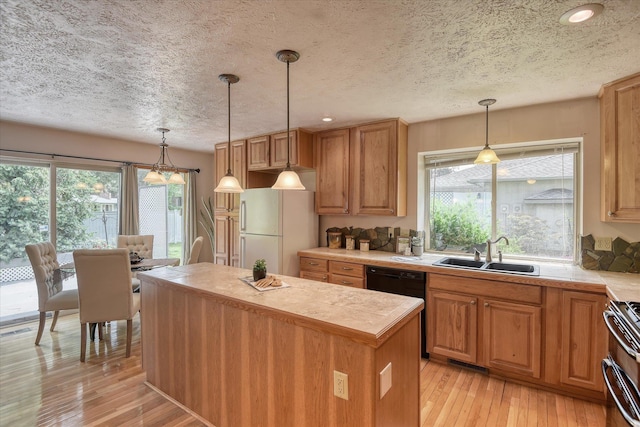 8410 N Pine Meadows Ln, Nine Mile Falls, WA 99026 - kitchen featuring freestanding refrigerator, a textured ceiling, light countertops, a center island, and light wood-style flooring