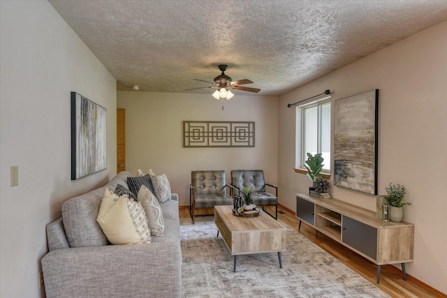 8410 N Pine Meadows Ln, Nine Mile Falls, WA 99026 - living area featuring wood finished floors, a textured ceiling, and a ceiling fan