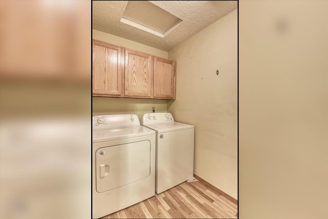 8410 N Pine Meadows Ln, Nine Mile Falls, WA 99026 - washroom with independent washer and dryer, cabinet space, a textured ceiling, light wood-type flooring, and attic access