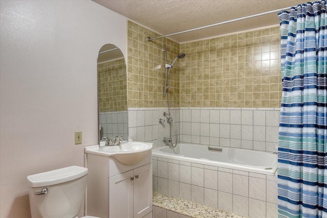 8410 N Pine Meadows Ln, Nine Mile Falls, WA 99026 - full bathroom featuring tiled shower / bath combo, vanity, and a textured ceiling