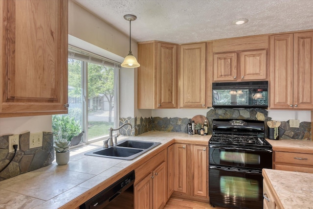 8410 N Pine Meadows Ln, Nine Mile Falls, WA 99026 - kitchen with black appliances, a textured ceiling, hanging light fixtures, tile counters, and light wood-style floors