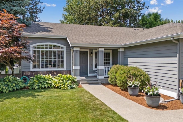 4216 S Tenfel Ln, Spokane, WA 99223 - doorway to property with covered porch, a lawn, and a shingled roof