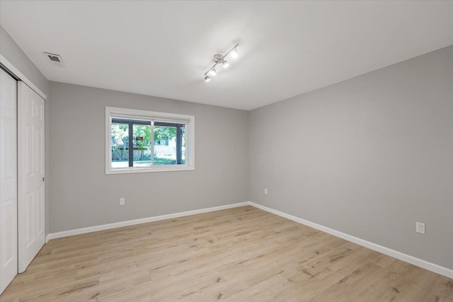 4216 S Tenfel Ln, Spokane, WA 99223 - unfurnished bedroom with light wood finished floors, a closet, and rail lighting