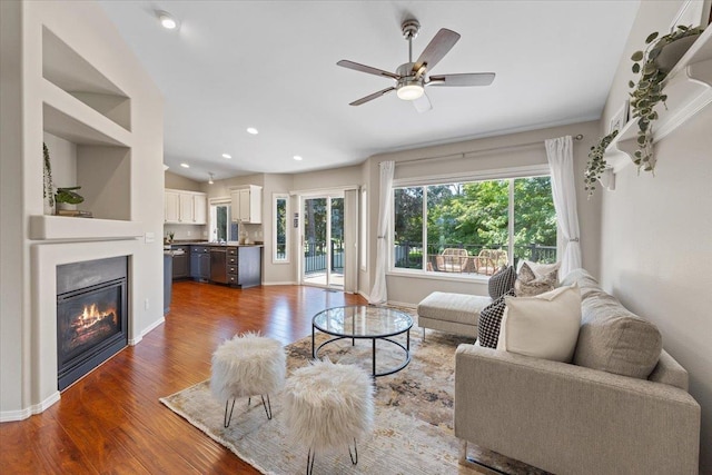 4216 S Tenfel Ln, Spokane, WA 99223 - living room with wood finished floors, ceiling fan, a glass covered fireplace, lofted ceiling, and recessed lighting