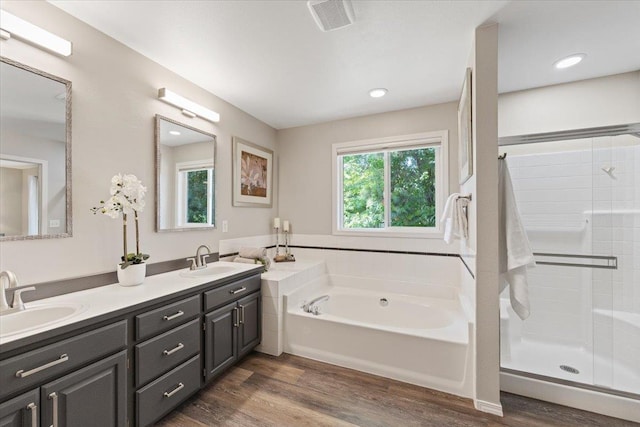 4216 S Tenfel Ln, Spokane, WA 99223 - full bath featuring double vanity, a stall shower, a garden tub, and wood finished floors