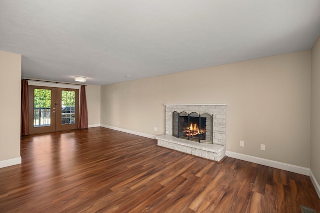 12925 E Valleyway Ave, Spokane Valley, WA 99216 - unfurnished living room featuring a brick fireplace, wood finished floors, and french doors