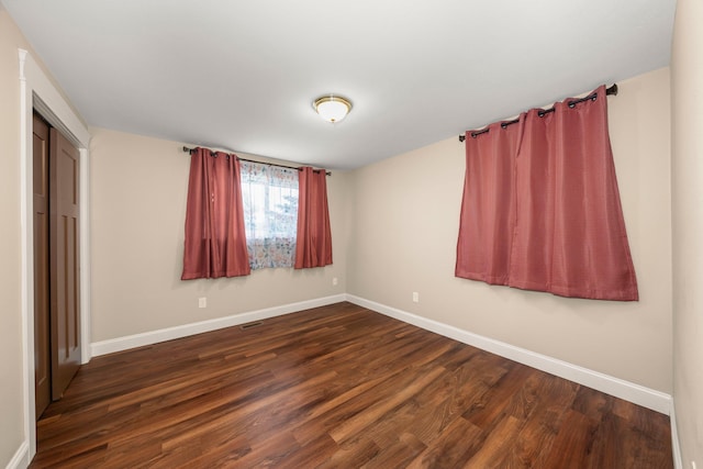 12925 E Valleyway Ave, Spokane Valley, WA 99216 - unfurnished bedroom featuring dark wood-type flooring and a closet