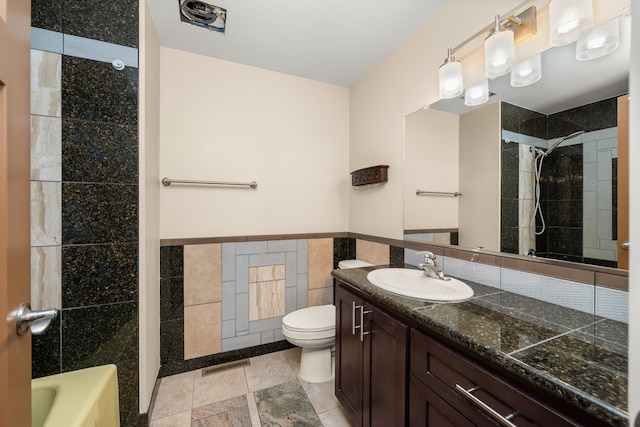12925 E Valleyway Ave, Spokane Valley, WA 99216 - bathroom with tile walls, vanity, wainscoting, and washtub / shower combination
