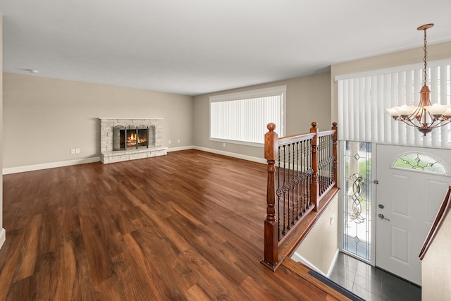 12925 E Valleyway Ave, Spokane Valley, WA 99216 - foyer featuring a chandelier, dark wood-type flooring, and a stone fireplace