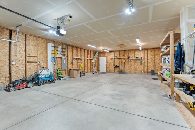 12919 E 39th Ln, Spokane Valley, WA 99206 - garage featuring electric panel, a workshop area, and a garage door opener