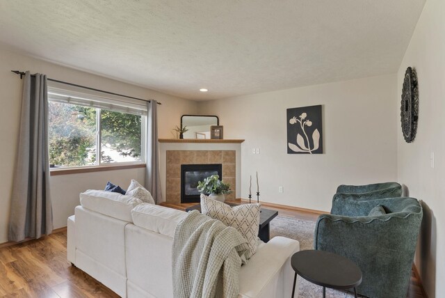 12919 E 39th Ln, Spokane Valley, WA 99206 - living area with wood finished floors, a tiled fireplace, and recessed lighting