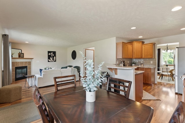12919 E 39th Ln, Spokane Valley, WA 99206 - dining space with light wood finished floors, recessed lighting, and a tiled fireplace