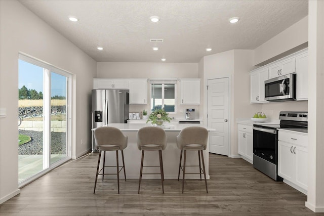 3768 S Keller Ln, Spokane Valley, WA 99206 - kitchen with stainless steel appliances, a center island, white cabinetry, light countertops, and recessed lighting