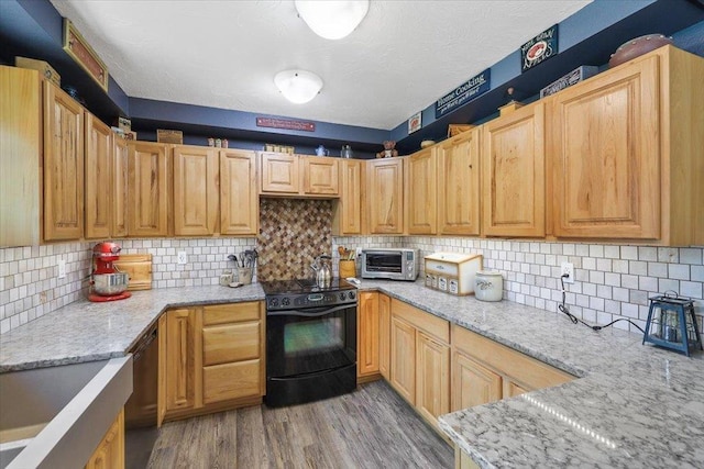 34225 N Arlington Ln, Deer Park, WA 99006 - kitchen with black appliances, light wood-type flooring, light stone countertops, and backsplash