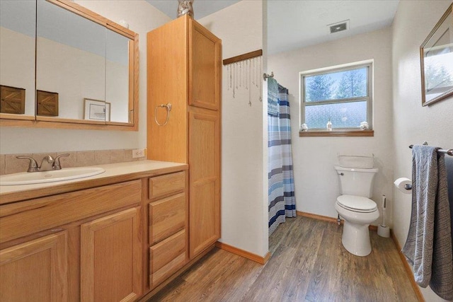 34225 N Arlington Ln, Deer Park, WA 99006 - full bathroom with wood finished floors, vanity, and a shower with shower curtain