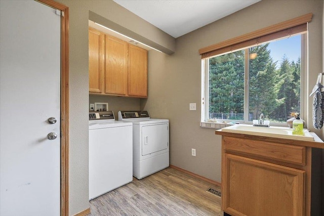 34225 N Arlington Ln, Deer Park, WA 99006 - laundry room featuring separate washer and dryer, cabinet space, and light wood-style flooring