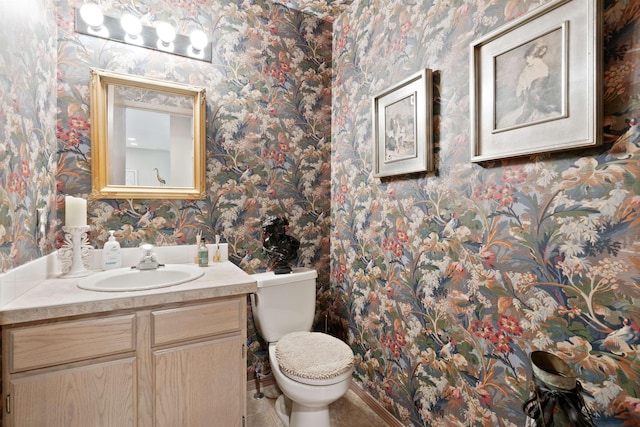3001 S Winthrop Ln, Spokane, WA 99203 - half bathroom with wallpapered walls, vanity, and tile patterned floors